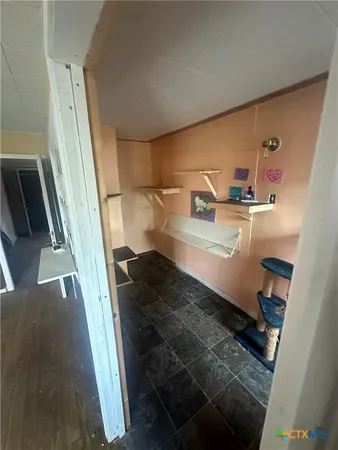 a view of a livingroom with a ceiling fan and window