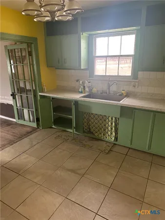 a view of empty room with wooden floor and windows