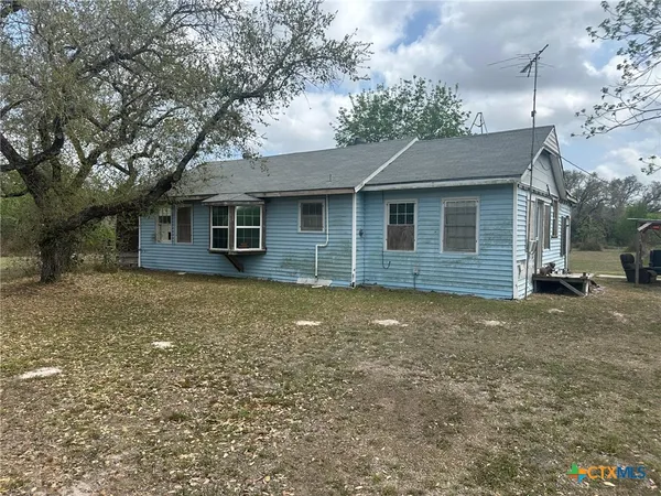 a large tree in front of a house