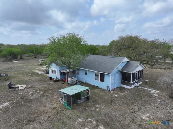 aerial view of a house with a yard and roof