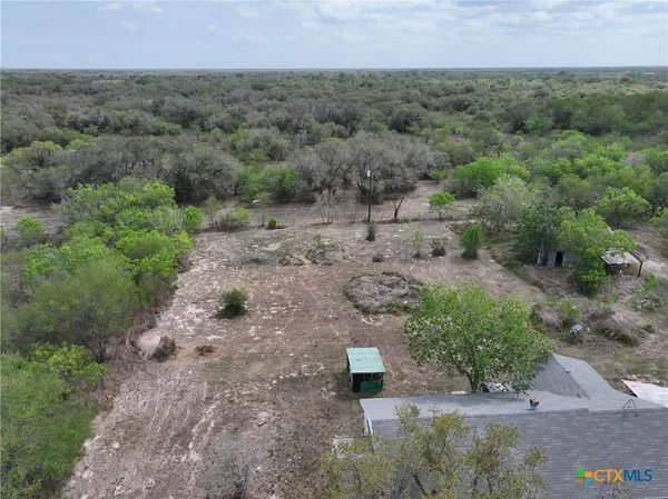 an aerial view of a house with a yard