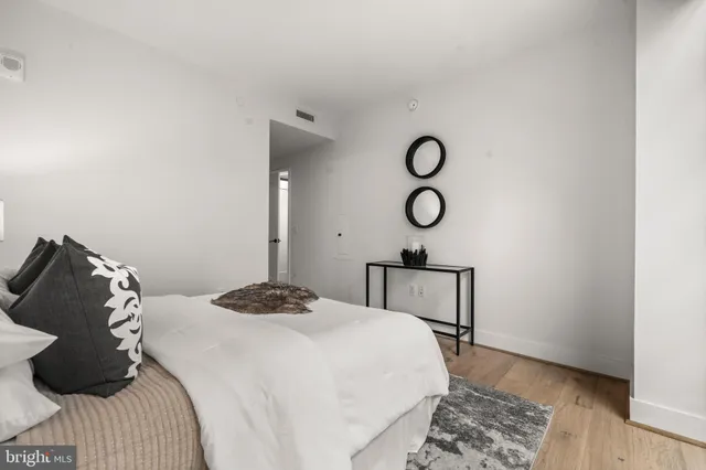 a bedroom with a bed and cabinets