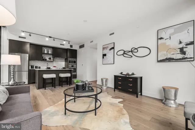 a living room with furniture kitchen view and appliances