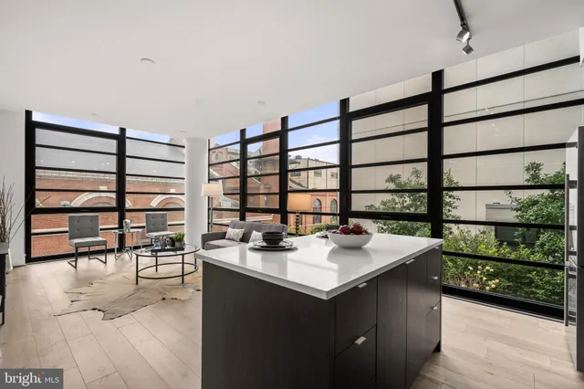 a kitchen with a sink a table and chairs in it