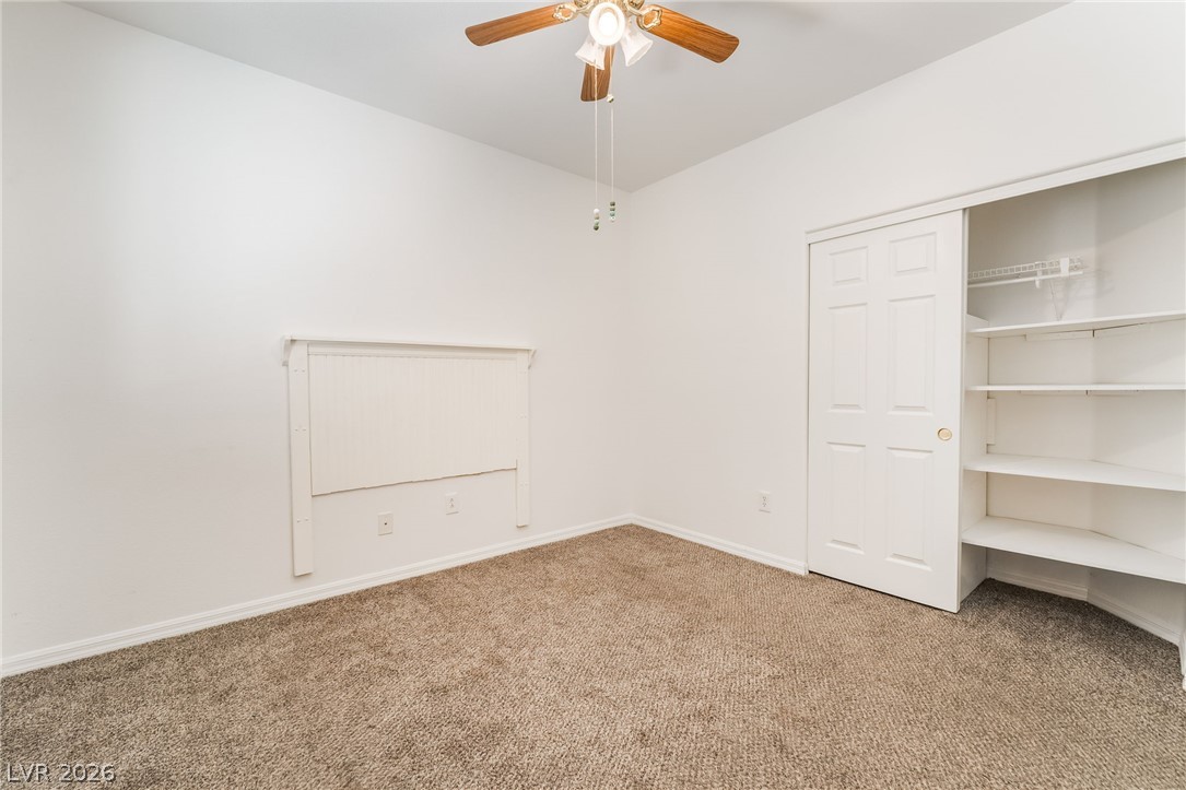 5389 Progresso Street Las Vegas, NV 89135 - Photo 24 of 41 A well-lit bedroom with plush carpet and convenient closet shelving.