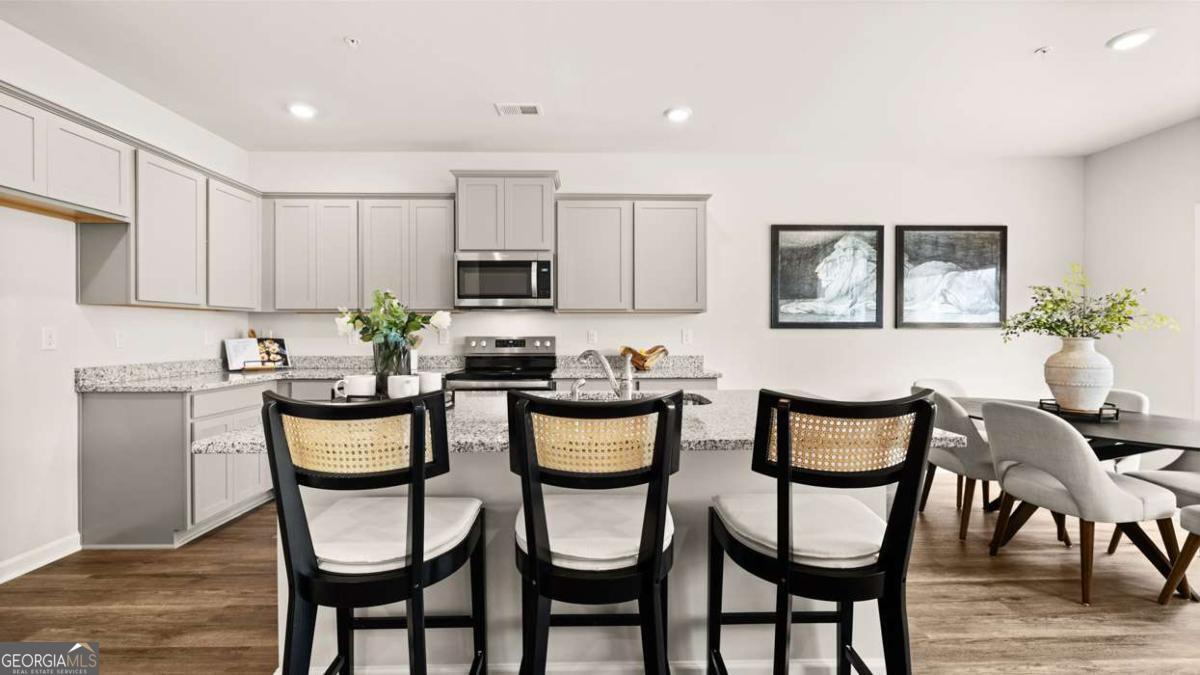 237 Sound Circle Stockbridge, GA 30281 - Photo 12 of 67 a kitchen with a dining table and chairs
