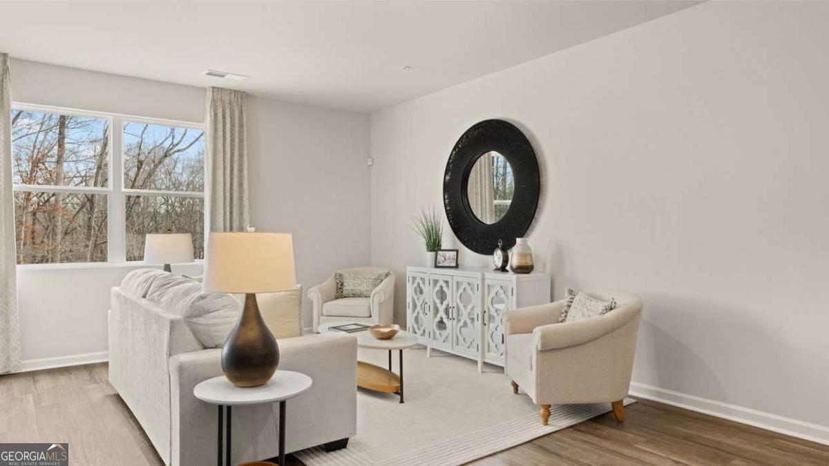 237 Sound Circle Stockbridge, GA 30281 - Photo 32 of 67 a living room with furniture and a large window