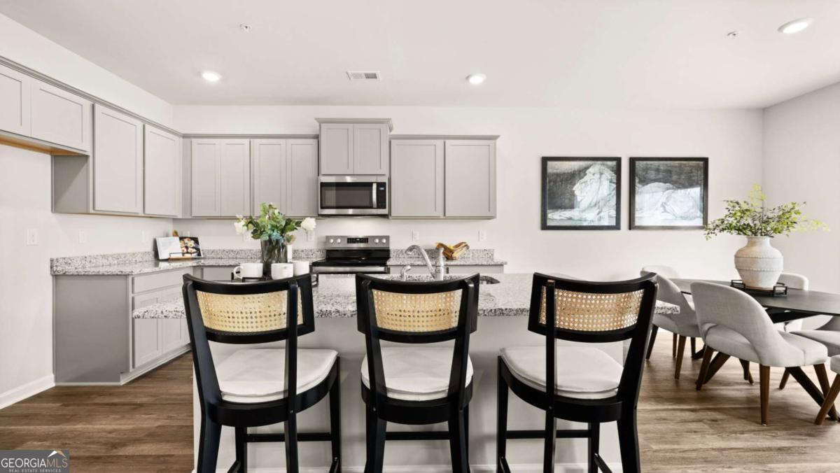 237 Sound Circle Stockbridge, GA 30281 - Photo 64 of 67 a kitchen with a dining table chairs and microwave
