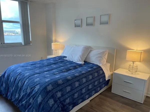 a bedroom with a bed and window