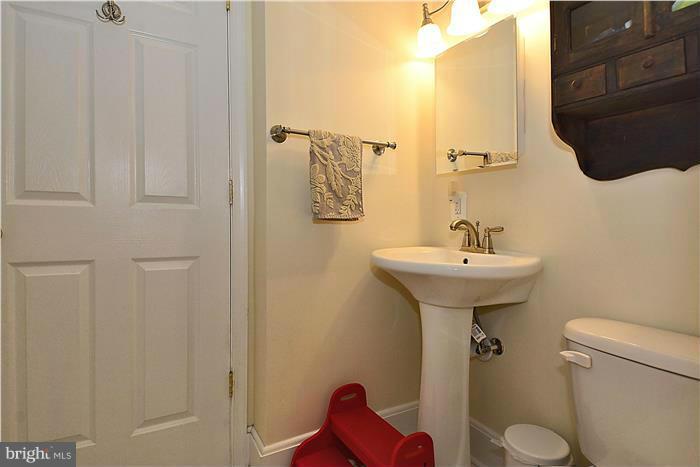 631 Ritchie Avenue Silver Spring, MD 20910 - Photo 15 of 30 a bathroom with a sink toilet and mirror