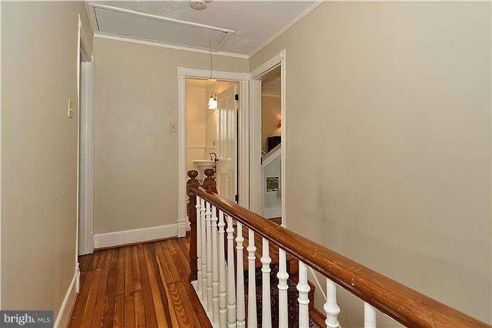 631 Ritchie Avenue Silver Spring, MD 20910 - Photo 23 of 30 a view of a hallway with wooden floor and staircase