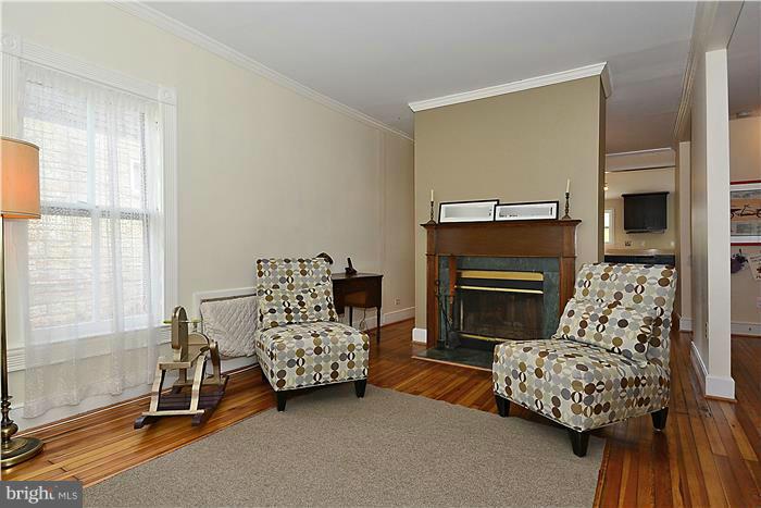 631 Ritchie Avenue Silver Spring, MD 20910 - Photo 4 of 30 a bedroom with a bed and a fireplace