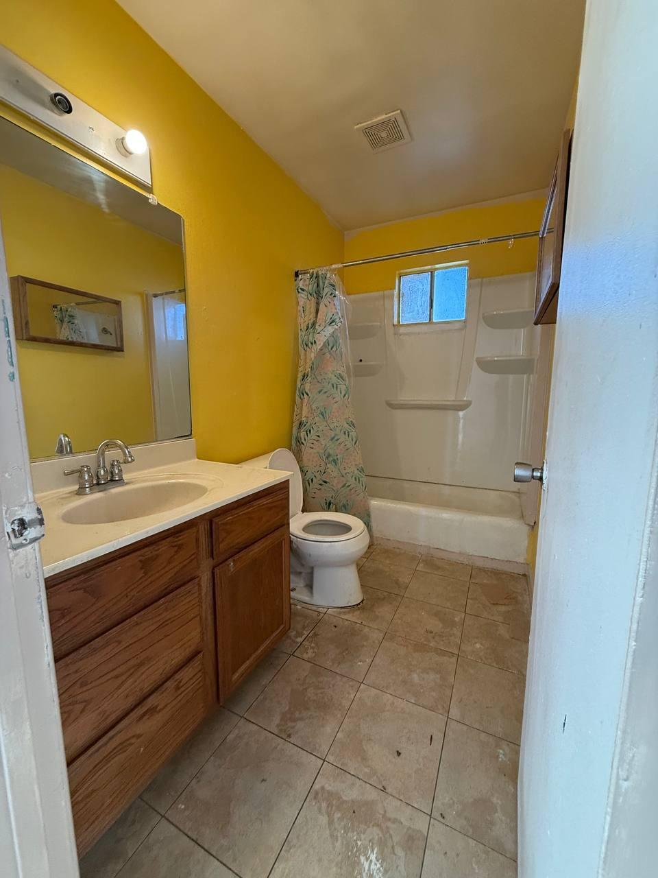 170 West Spring Lane Lemoore, CA 93245 - Photo 11 of 25 a bathroom with a sink a toilet and shower