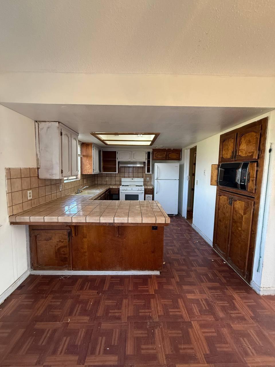 170 West Spring Lane Lemoore, CA 93245 - Photo 8 of 25 a large kitchen with cabinets table and stainless steel appliances