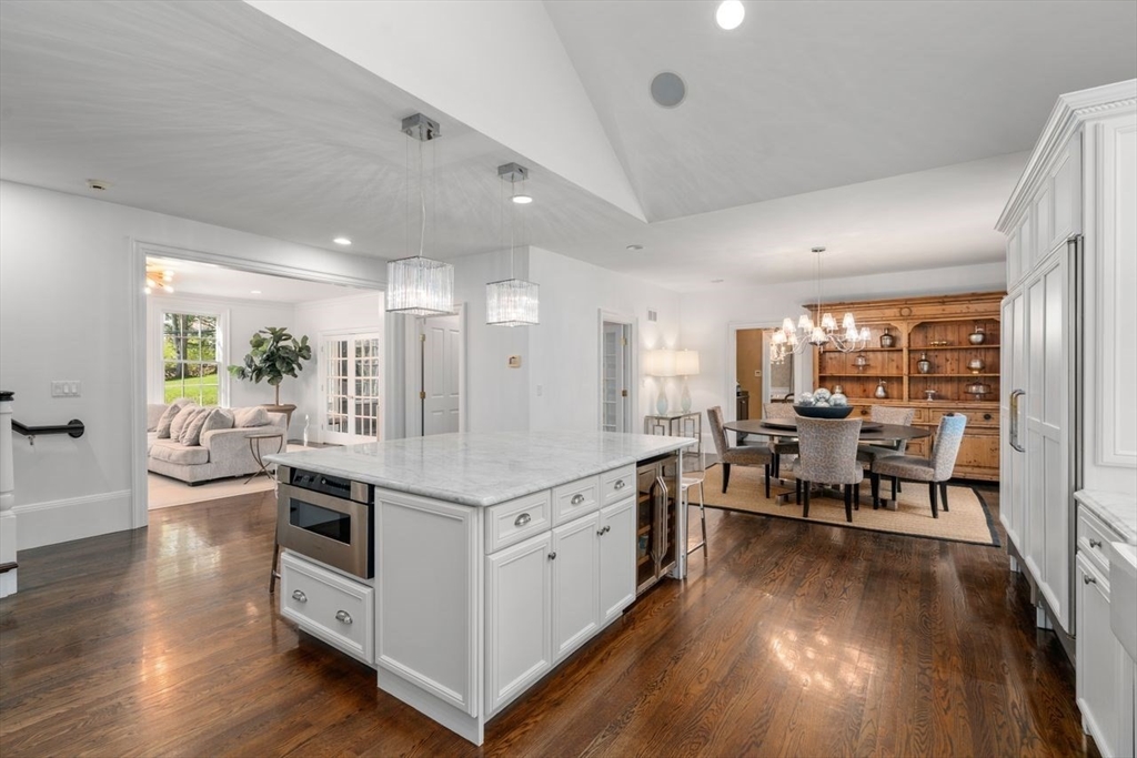 22 Plymouth Road Wellesley, MA 02481 - Photo 11 of 37 a living room with stainless steel appliances kitchen island granite countertop furniture a desk and chair with wooden floor