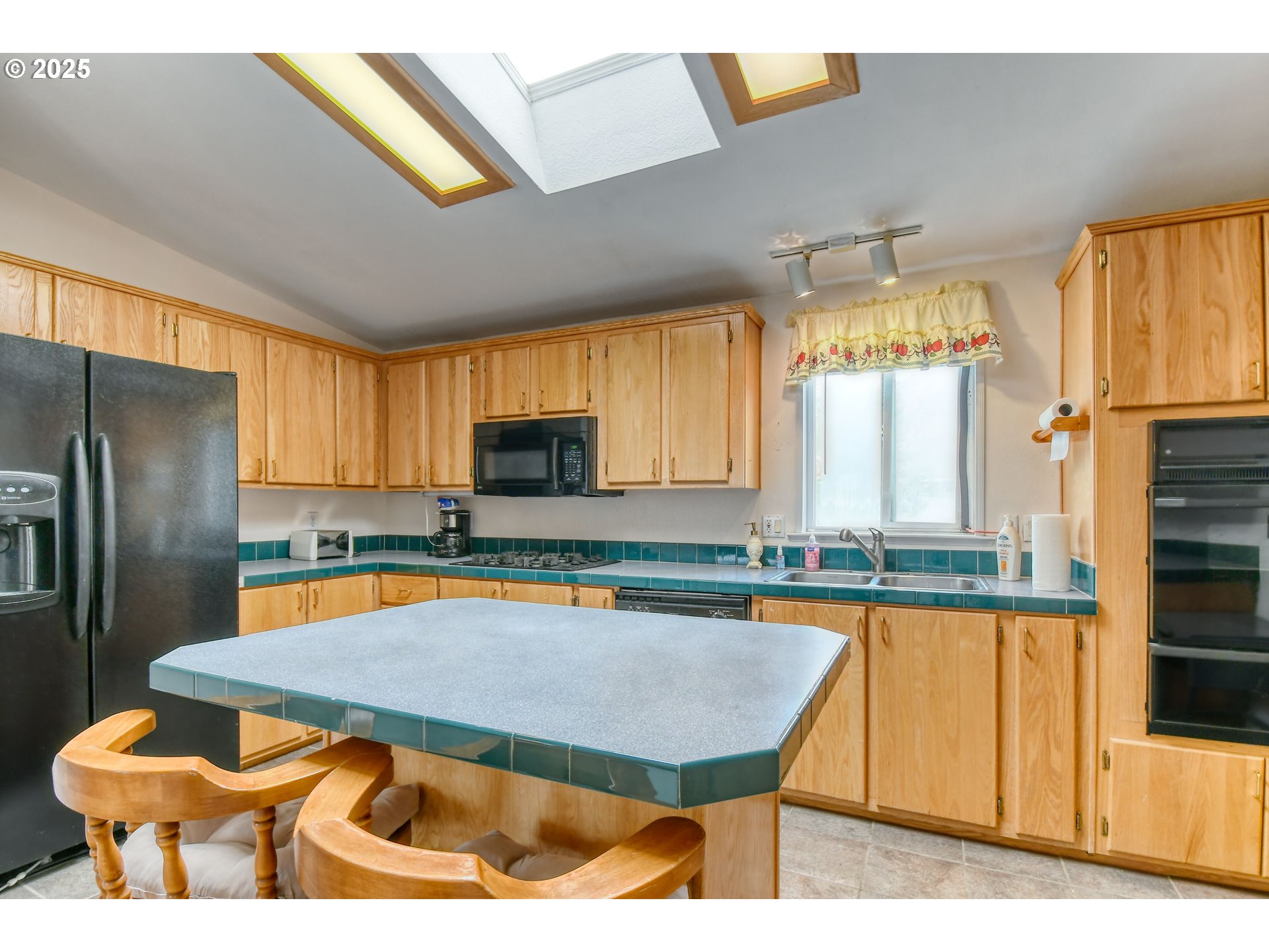 415 Northeast 40th Street Pendleton, OR 97801 - Photo 12 of 36 a kitchen with stainless steel appliances kitchen island granite countertop a table chairs in it and a window