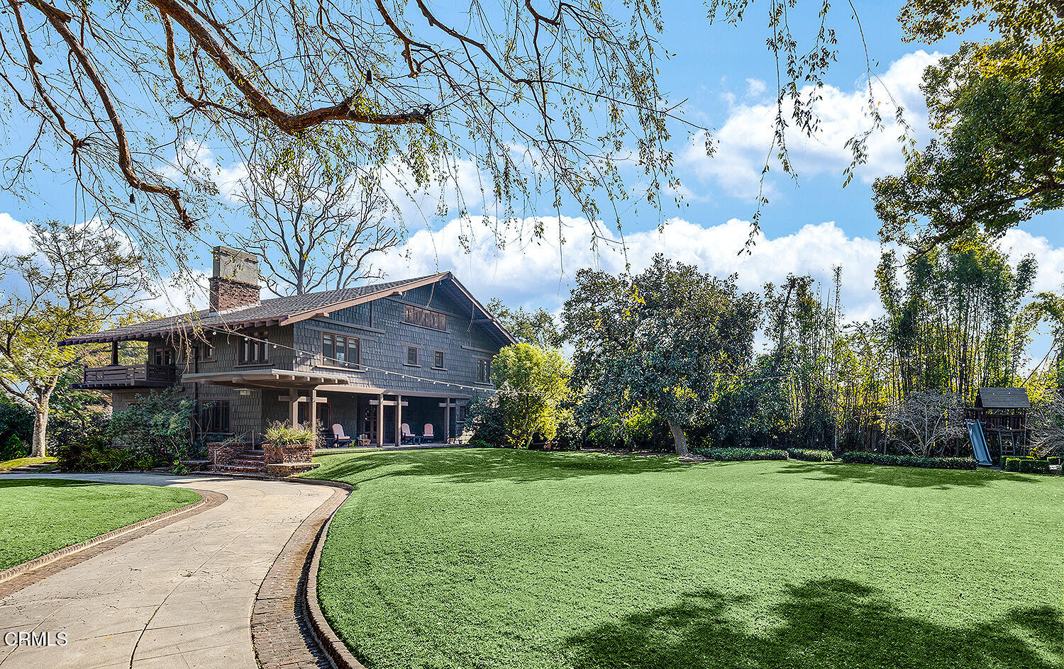 1344 Hillcrest Avenue Pasadena, CA 91106 - Photo 1 of 23 a view of a brick house next to a yard with big trees