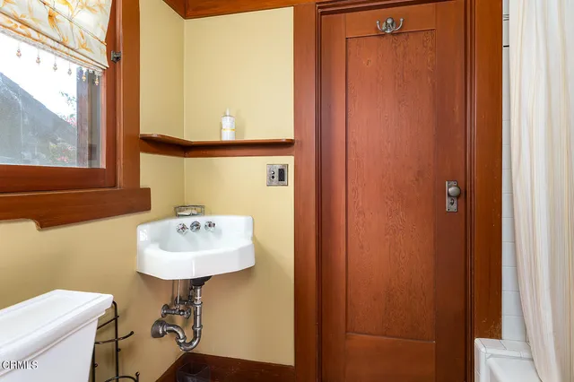 a bathroom with a sink toilet and a mirror