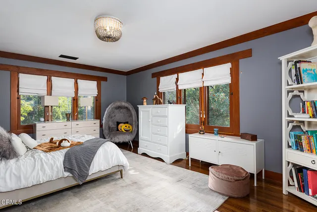 a bedroom with a sink and a dresser