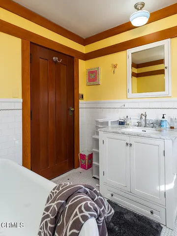 a bedroom with a bed a couch and a large window