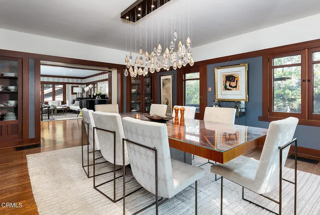 a view of a dining room with furniture a chandelier and wooden floor