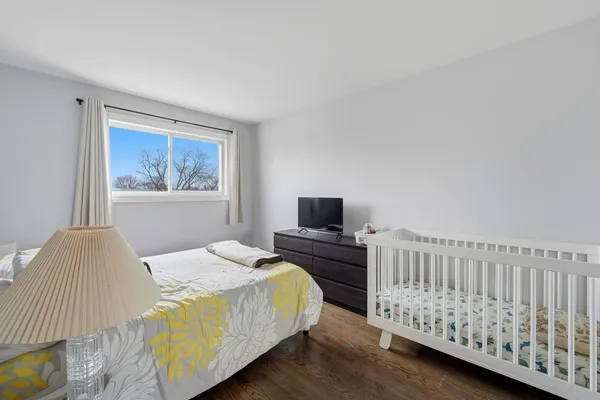 a bedroom with a bed a table and chair