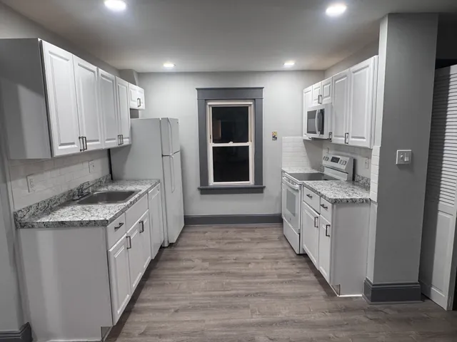 a kitchen with stainless steel appliances granite countertop a stove and a sink