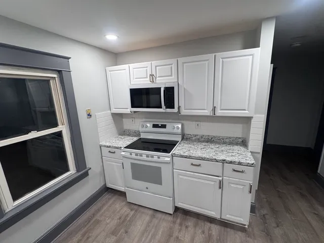 a kitchen with a stove microwave and refrigerator
