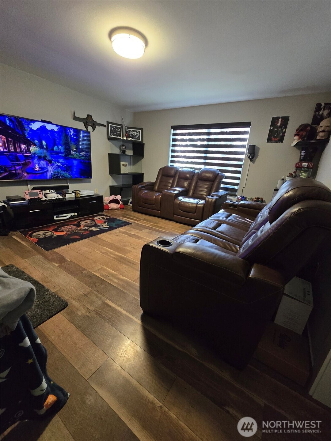 6611 Crescent Beach Road Northwest Vaughn, WA 98394 - Photo 11 of 17 a living room with furniture a flat screen tv and a window
