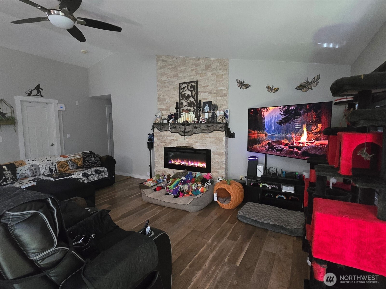 6611 Crescent Beach Road Northwest Vaughn, WA 98394 - Photo 14 of 17 a living room with furniture fireplace and flat screen tv