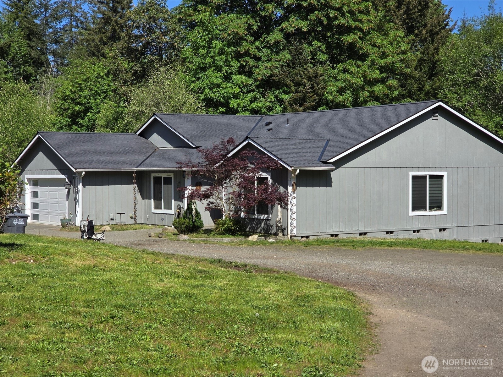 6611 Crescent Beach Road Northwest Vaughn, WA 98394 - Photo 3 of 17 a view of a house with a yard and trees