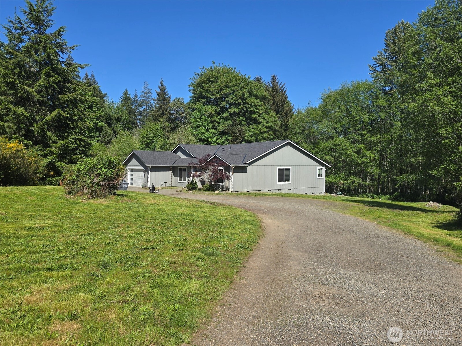 6611 Crescent Beach Road Northwest Vaughn, WA 98394 - Photo 4 of 17 a house with huge green field in front of it