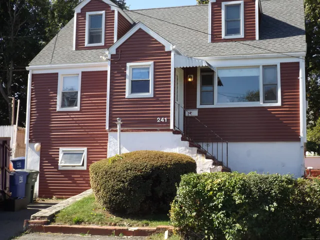 a view of a house with a yard and large windows