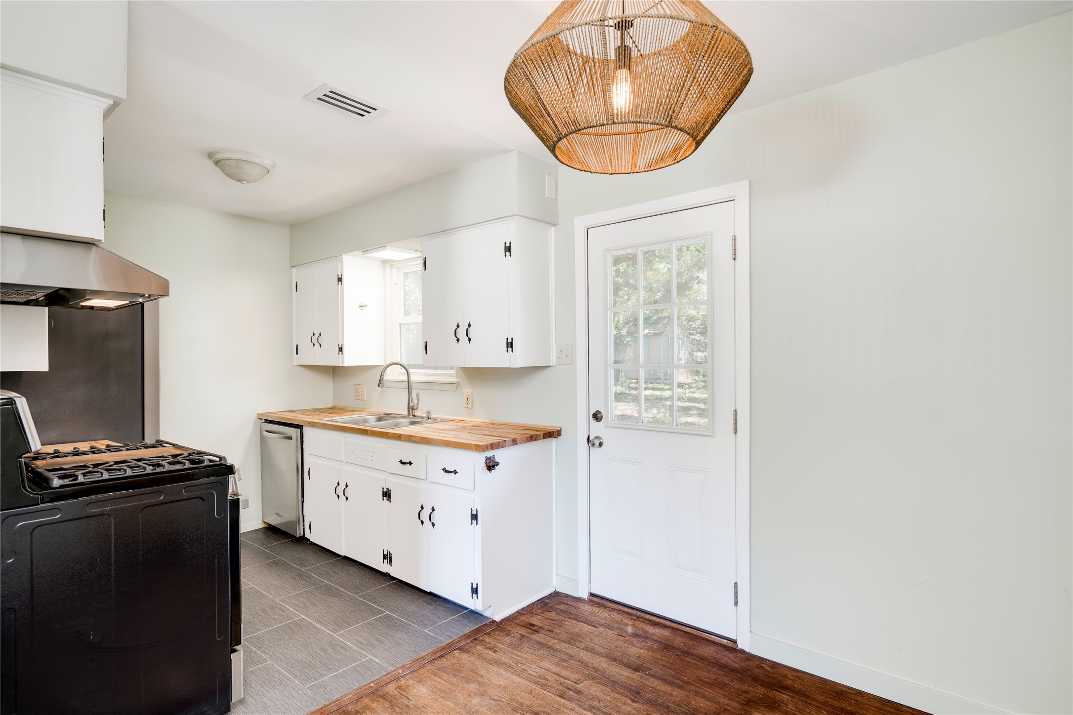1707 Overhill Drive Austin, TX 78721 - Photo 8 of 36 A well-appointed kitchen features a gas range, dishwasher, and ample cabinetry with natural light.