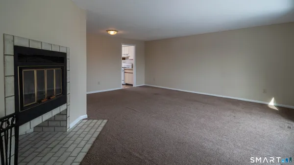 an empty room with closet and a ceiling fan