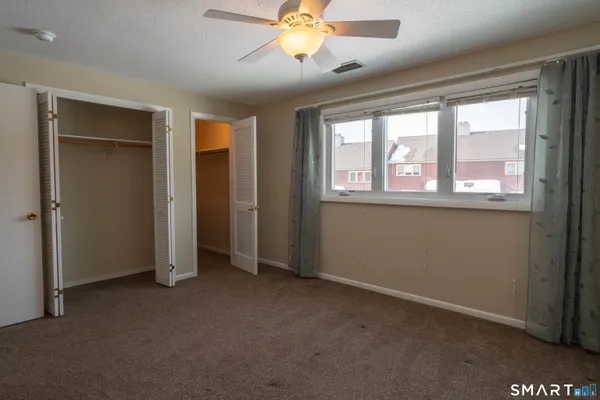 a view of empty room with a fireplace