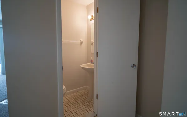 an empty room with a ceiling fan and window