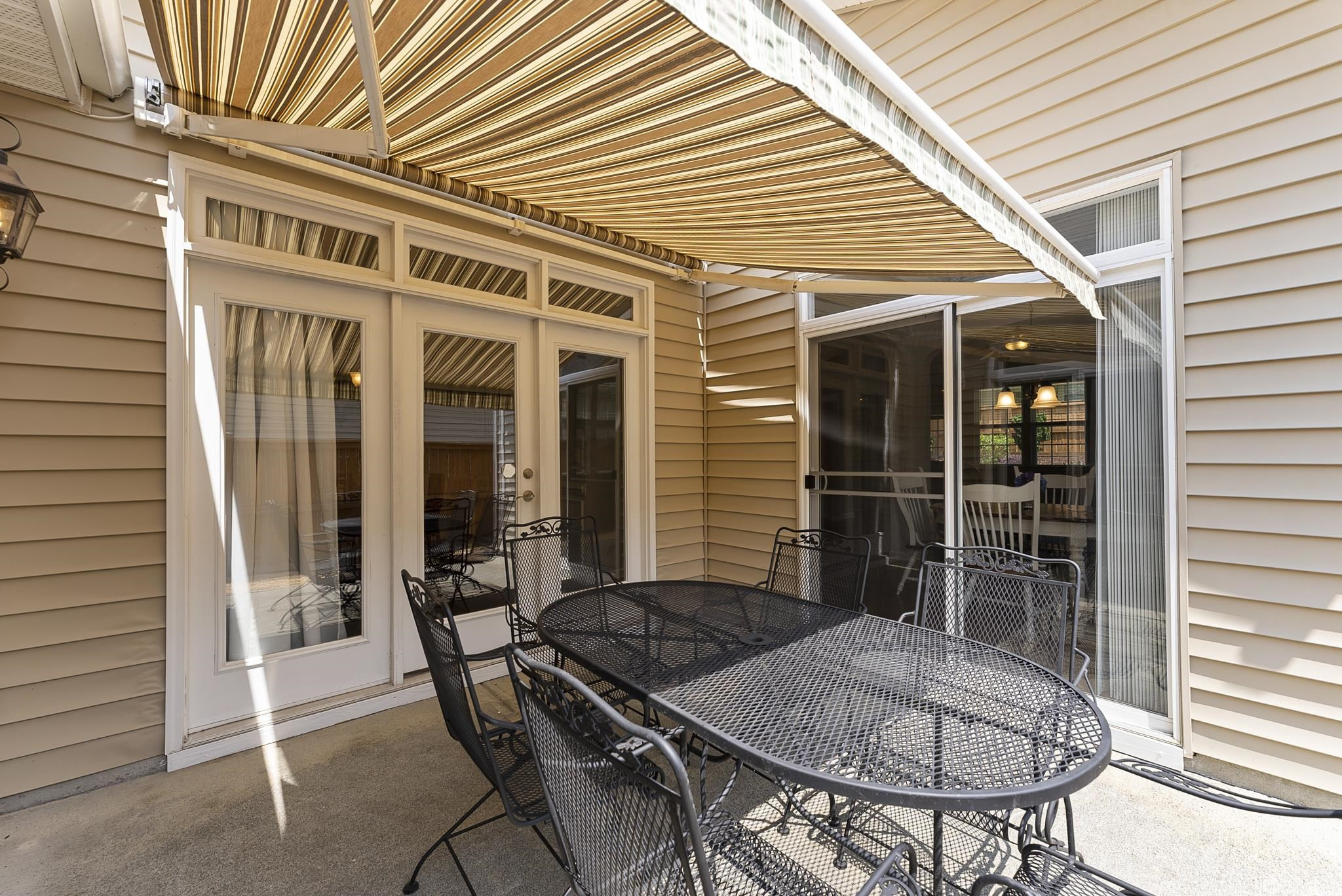 8508 Lasilla Way Raleigh, NC 27616 - Photo 30 of 42 Patio opens up to kitchen, dining and office with retractable awning Patio with retractable awning