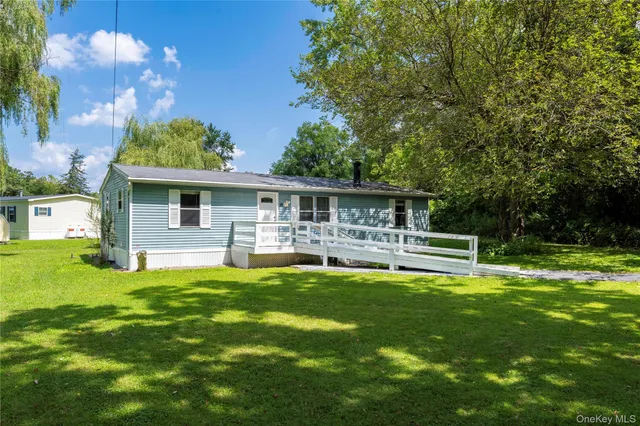 a view of a house with a yard porch and sitting area