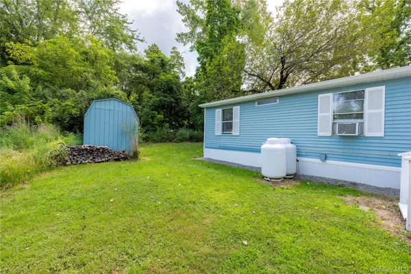 a view of a house with backyard and sitting area