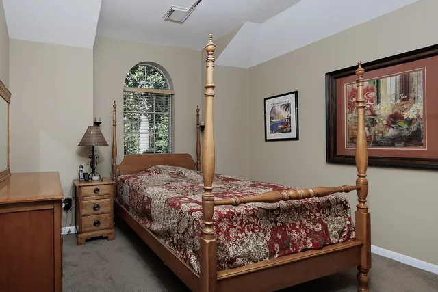 a bedroom with a large bed and a window