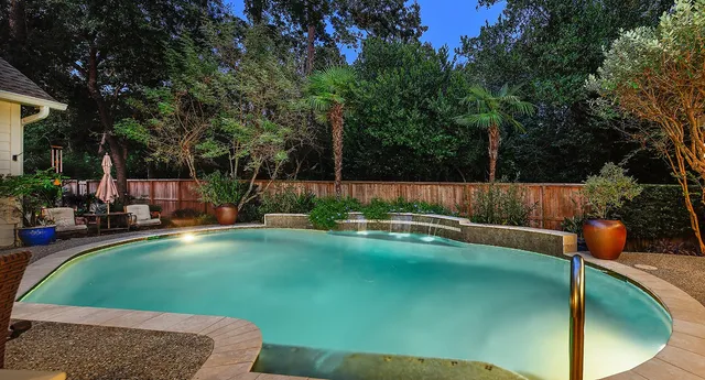a view of a backyard with swimming pool