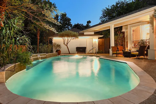 a view of a swimming pool with outdoor seating