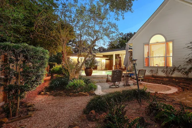 a view of a house with backyard and sitting area