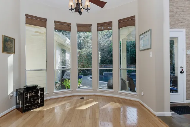 a view of a bedroom with a bed and wooden floor