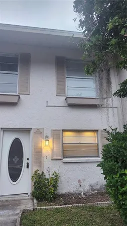 a front view of a house with a yard garage and wooden floor