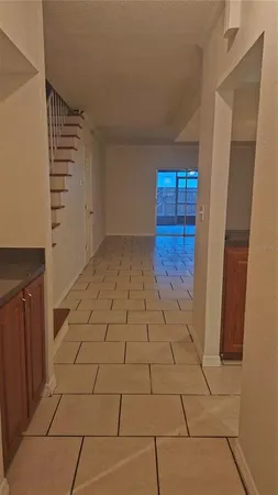 a view of an empty room and stairs