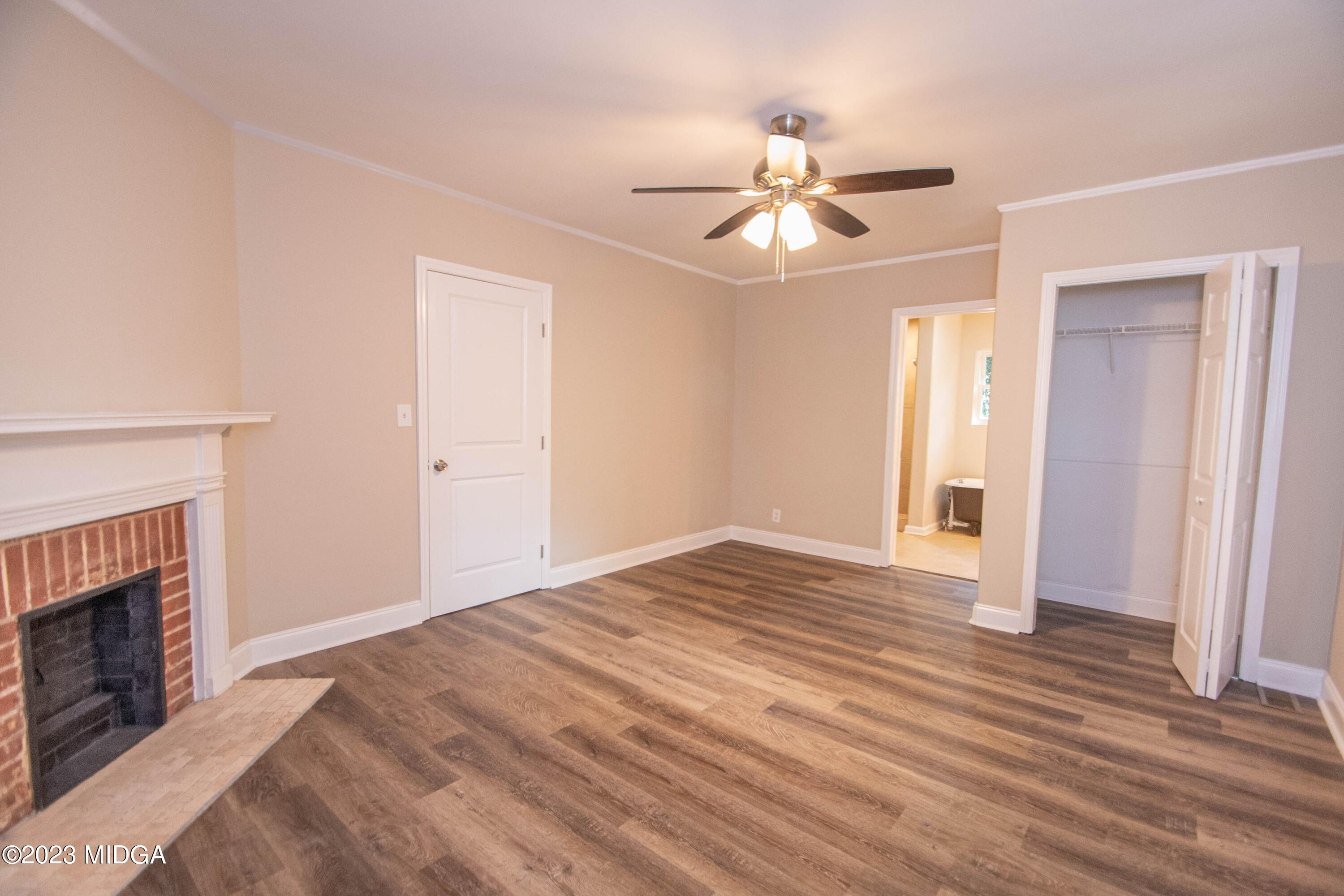 225 R Street Northwest Thomaston, GA 30286 - Photo 19 of 22 a view of an empty room with wooden floor fireplace and a window
