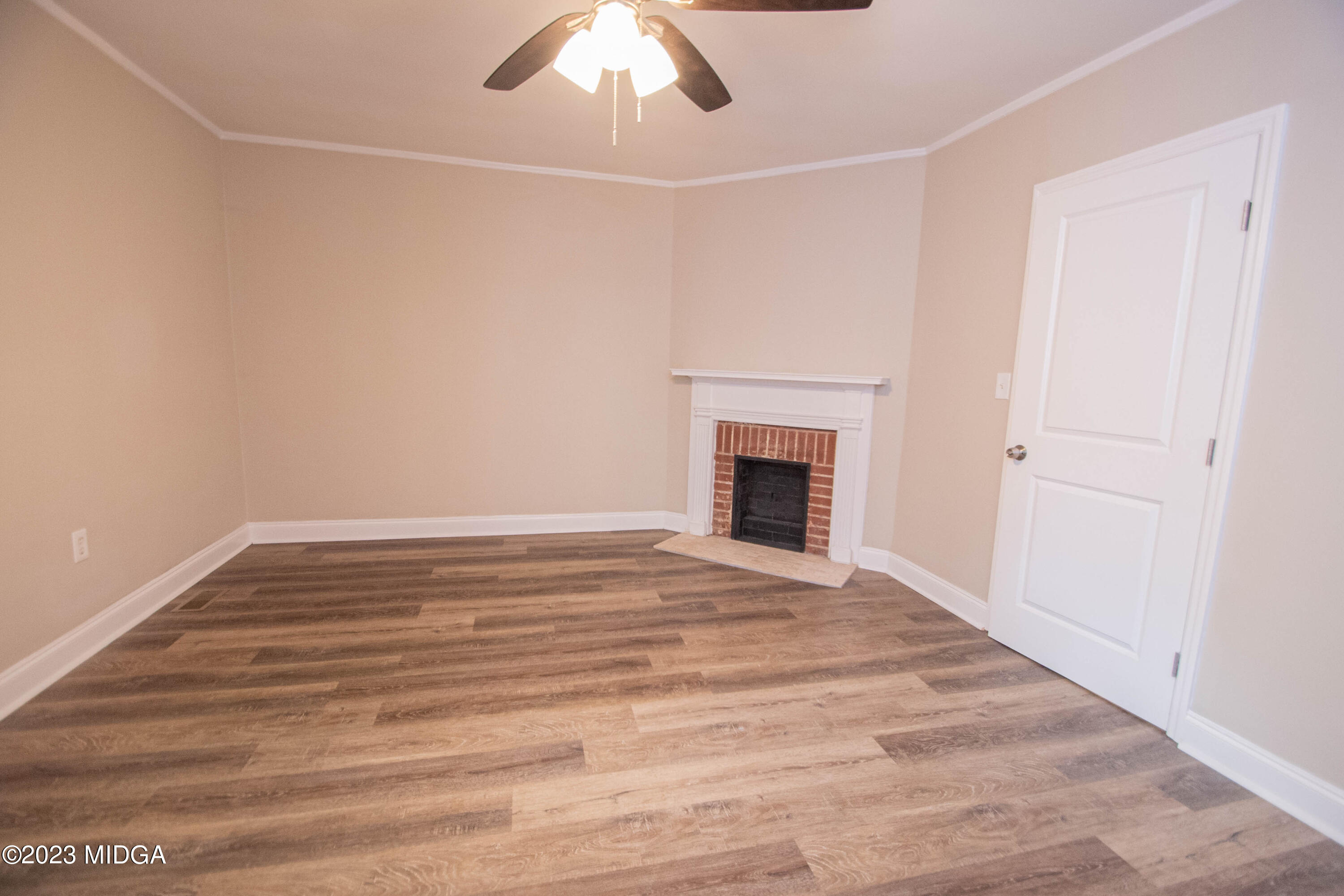 225 R Street Northwest Thomaston, GA 30286 - Photo 3 of 22 a view of empty room with fireplace and fan