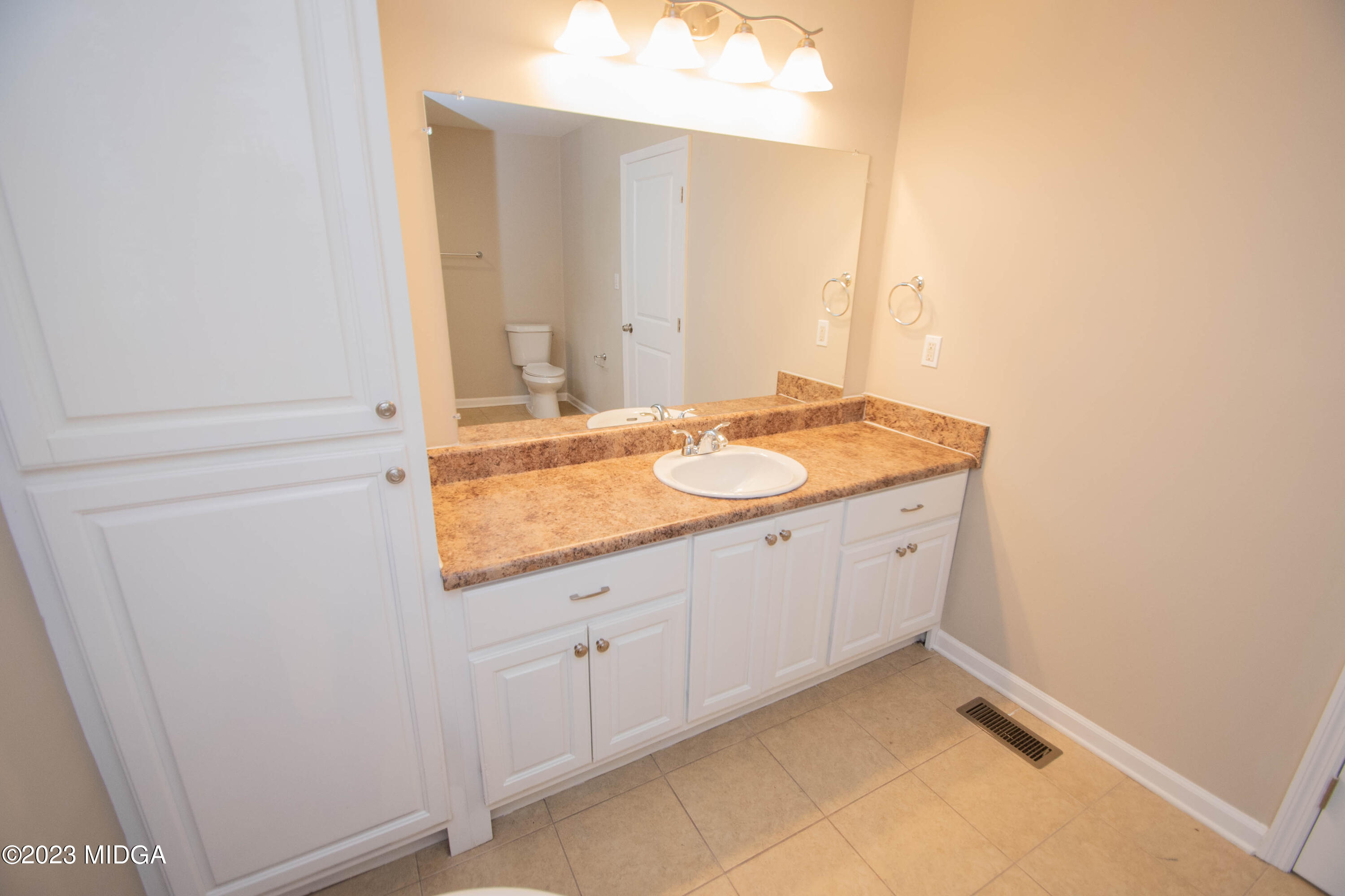 225 R Street Northwest Thomaston, GA 30286 - Photo 5 of 22 a bathroom with a granite countertop sink and a mirror